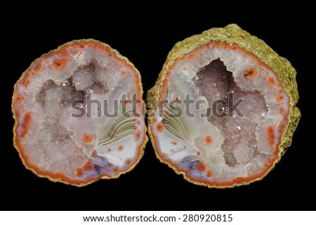 A cross section of agate stone with geode on a black background.  Origin:  Morocco, Asni.