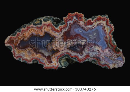 A cross section of agate stone on a black background.  Origin:  Morocco, Atlas Mountains