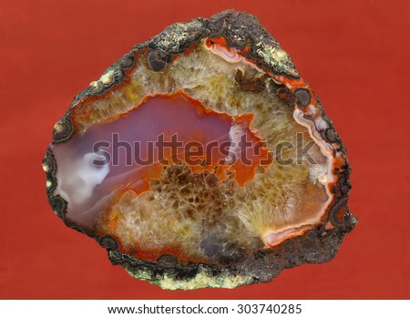 A cross section of agate stone on a black background.  Origin:  Morocco, Atlas Mountains