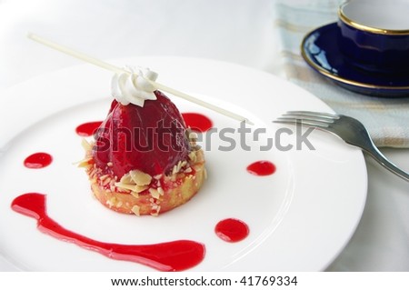 A delicious bite sized Strawberry Tart. On a plate and ready to eat