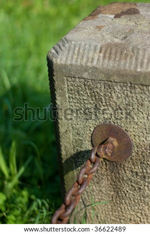 Old foot-stone with chain