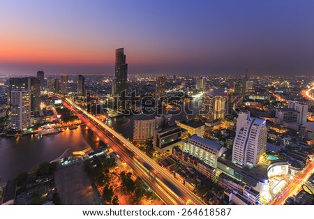Cityscape of River in Bangkok city with high office building in night time