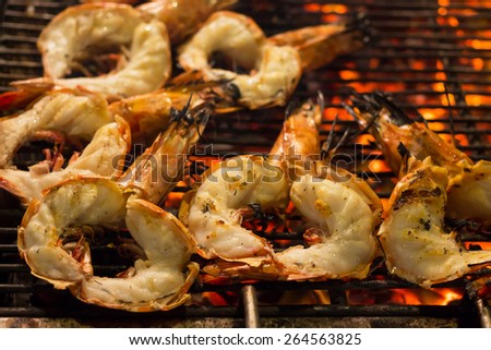 Tiger Prawn barbecue on a gridiron over fire at the seafood night market.