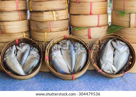 Thai gulf mackerel fish steamed on bamboo basket in different sizes for display at a fish market ; Thai people called this fish is Pla-too