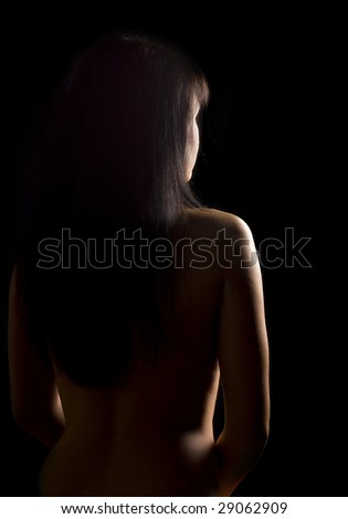 Nude female silhouette on black background