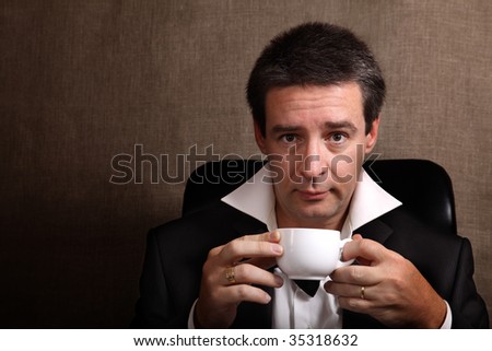 Man taking rest after party with a cup of coffee