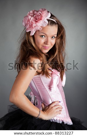 Cute dressed-up girl with silk flowers in the hair