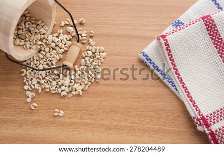 Millet in the tank and table linens on a wooden table.