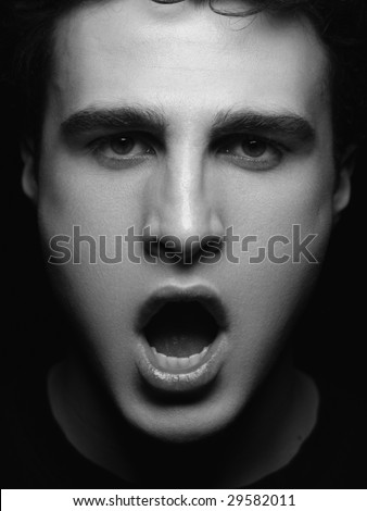 Face of young man with open mouth