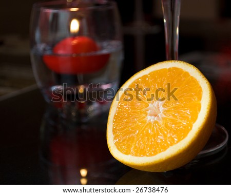 Close-up of orange at a romantic candle light dinner