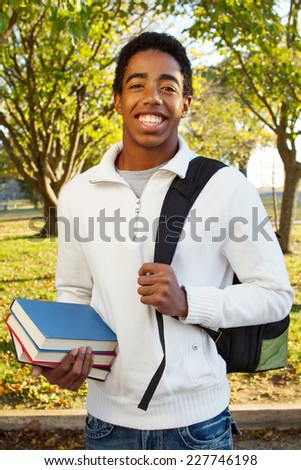 Student at school holding books and a book bag