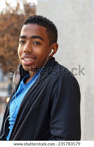 African American teenage boy listening to music.