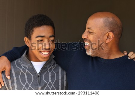 Father and son talking and laughing.