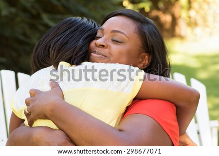 African American mother hugging her daughter.