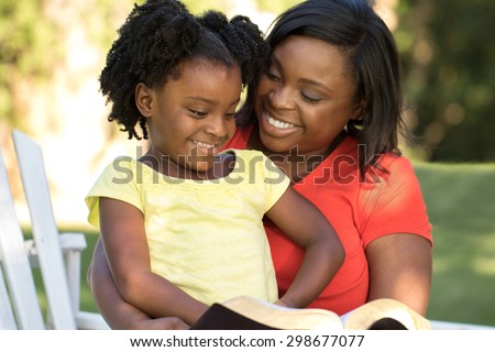 African American mother reading to her daughter