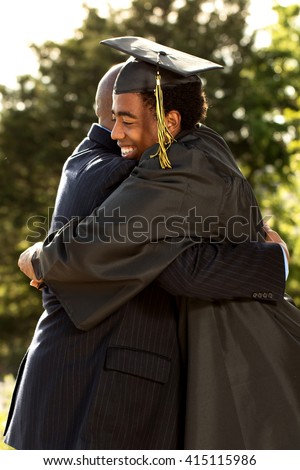 Father and son hugging  at his son's graduation.