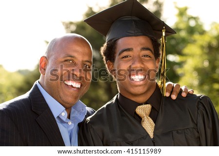 Father and son hugging  at his son\'s graduation.