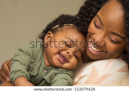 Portrait of woman relaxing at home with her little girl.