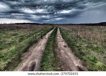 dirt road going into the eye of the storm.