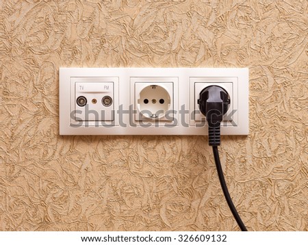 Two electric outlets with plug and sockets for television and radio