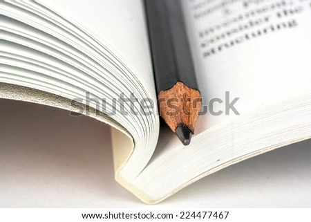 Open book on economics and pencil closeup shot