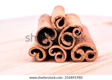 A pile of cinnamon sticks on the table close-up