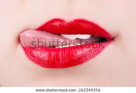 Girl with painted lips bites his tongue