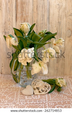 White tulips on pattern table cloth