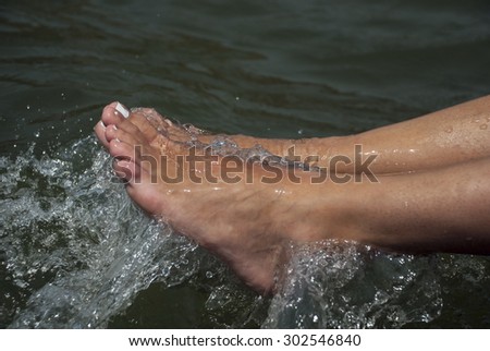 A view of feet in bubbling water.