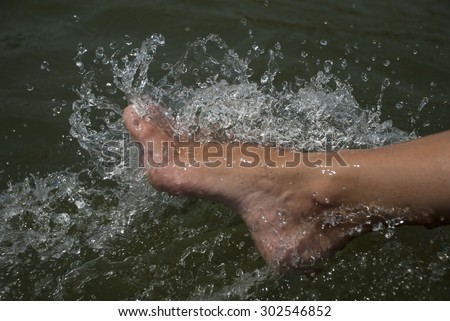 A view of feet in bubbling water.