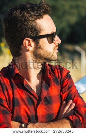 Man with sunglasses with arms crossed
