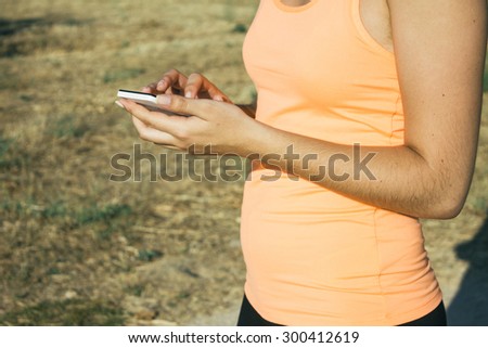 Runner woman using her phone