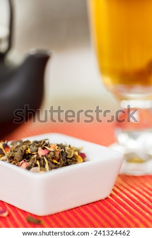 Loose leaf tea, tea pot and cup. Shallow depth of field