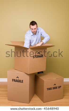 Man packing boxes with arm in box