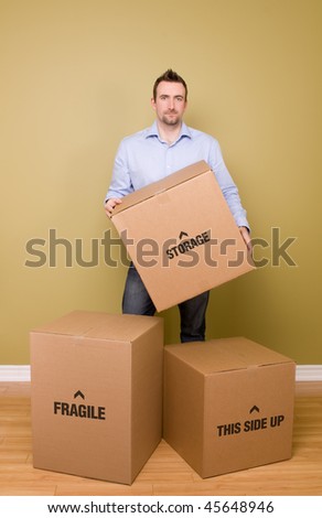 Man holding packed box, getting ready to move