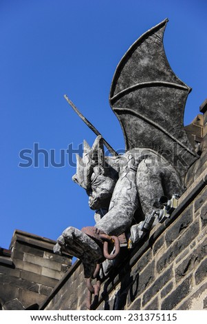 Gargoyle with Hand Extended Sits on Top of Wall at Eastern State Penitentiary Historic Site, Philadelphia, Pennsylvania