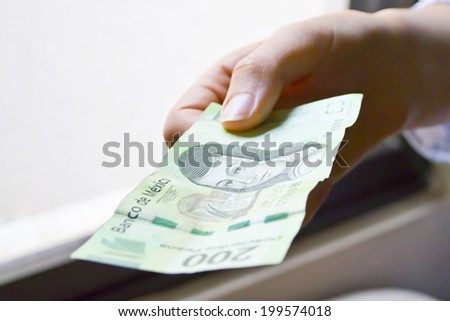 Hand holding a ticket, holding money, Hand paying with a ticket