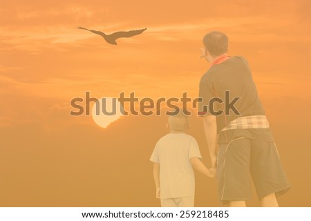 Double Exposure Effect orange screen of sunset father and son point look at eagle bird fly on sky