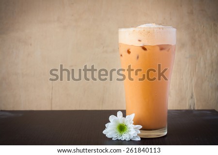 Iced Milk Tea on a brown wooden table in summer