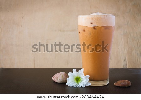 Iced Milk Tea  on a wooden table in summer