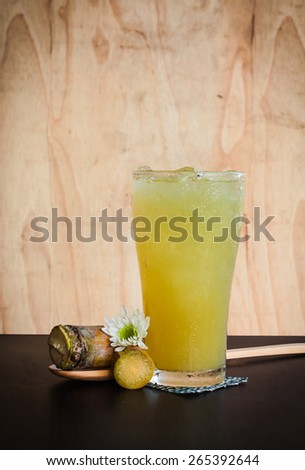 Iced drinks from sugar cane on wooden table in summer