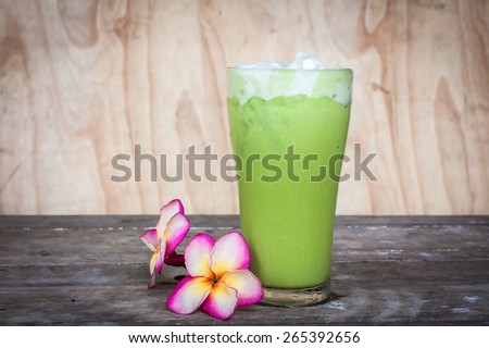 Iced Milk Green Tea on a wooden table in summer
