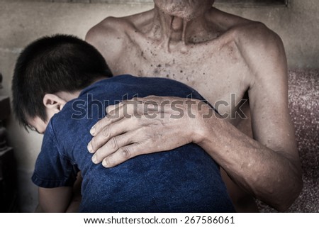Grandfather with grandson embrace. Love and caring   an old man wrinkled hands touches head back boy