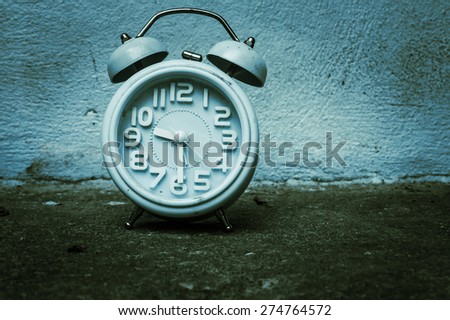 vintage of old clock on old cement wall
