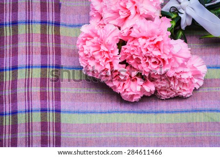 pink carnation floral on ion violate cloth background