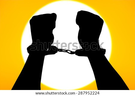 silhouette of hand man in shackle on big sunset background