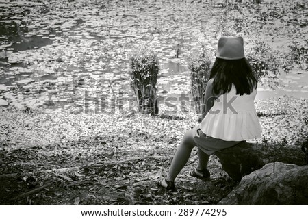 black and white of little asian cute girl  standing alone with white bear at river