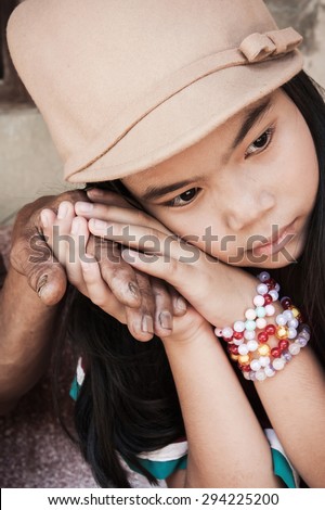 vintage of asian kids little girl hand touches and holds an old man wrinkled hands at face of her
