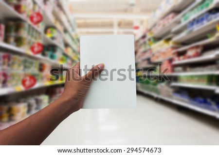 hand women shopping and  holding empty notebook for check list her buy in the supermarket