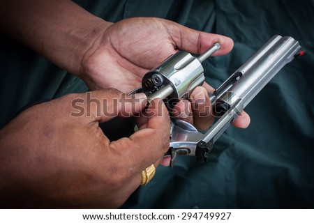 hand man holding show gun  storage cylinder .357 magmun of revolver handgun